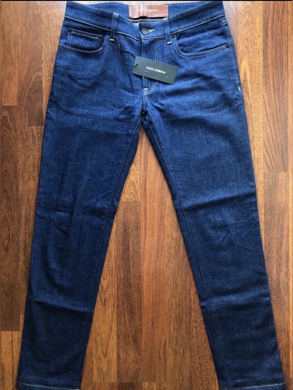Brand new Dolce & Gabbana Navy Denim Jeans with Tan Leather Logo Patch